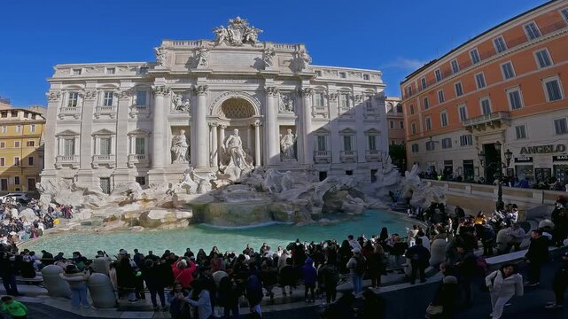 Aerial view of crowd of people and Trevi Fountain in Rome city. It is it is the largest Baroque fountain in the Rome and one of the most famous fountains in the world, slow motion