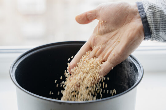 Pour buckwheat groats into a saucepan to cook porridge