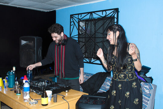 DJ Plays Music While a Woman Dances in outdoor Space