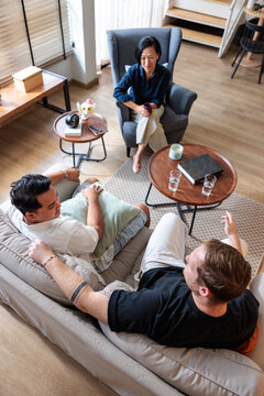 Therapist facilitating a counseling session with two adult men