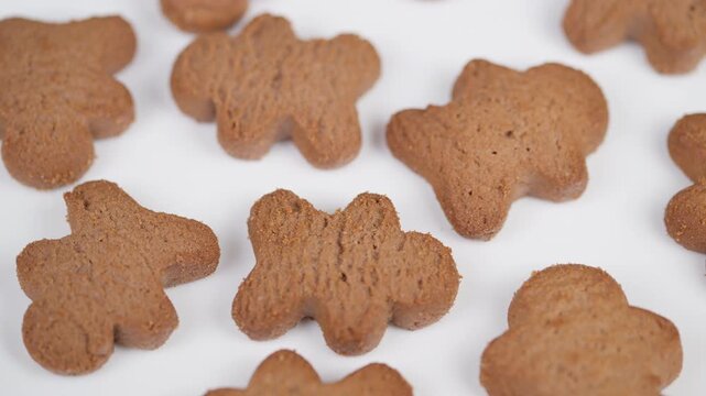 Decorative spicy cookie pattern. Closeup of festive gingerbread treats arrangement. Detailed image of neatly arranged gingerbread cookies in cozy holiday bakery style