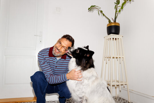 Dog licks smiling owner's face
