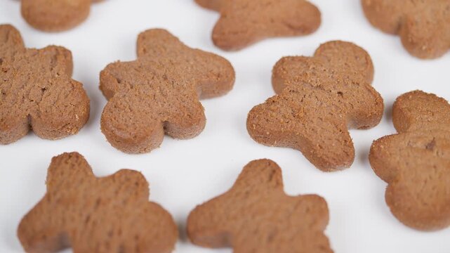 Gingerbread treats snapshot. Mini spiced cookies photographed aesthetically. Stylish display of small spiced biscuits arranged playfully for festive packaging or catalogs