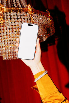 Phone Mockup Held Against Red Luxury Interior