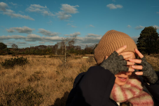 Woman Shielding Eyes in Winter Sun