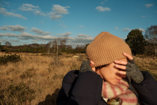 Woman Shielding Eyes in Winter Sun