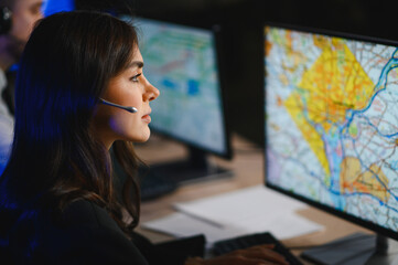Female dispatcher monitoring map on computer screen