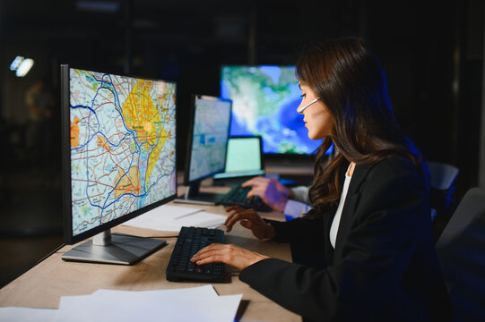 Dispatcher monitoring logistics operations on multiple screens