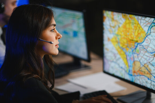 Female dispatcher monitoring map on computer screen