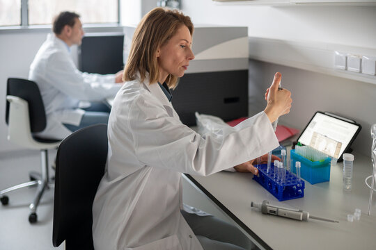 Scientist Working in Lab With Test Tubes and Equipment