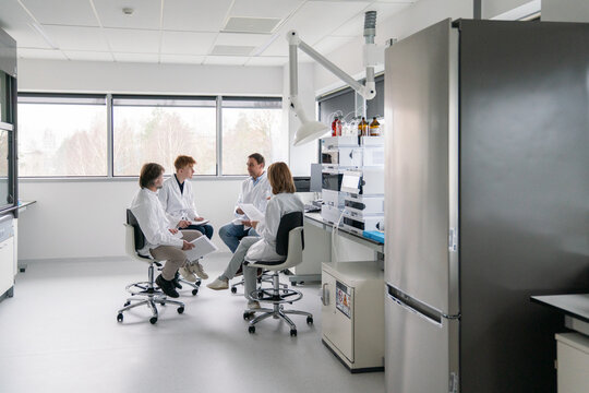 Group of Scientists Discuss Research Findings 