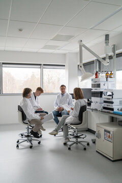 Scientists Discuss Research in Laboratory 