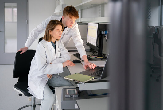 Scientists Work Together at a Lab Desk 