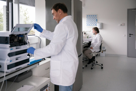 Lab Workers Conduct Tests in Modern Science Facility 