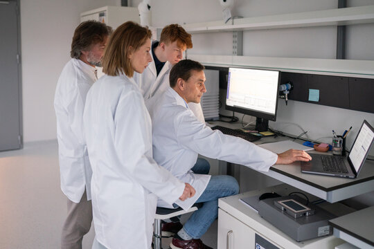 Researchers Work Together in a Lab Analyzing Data