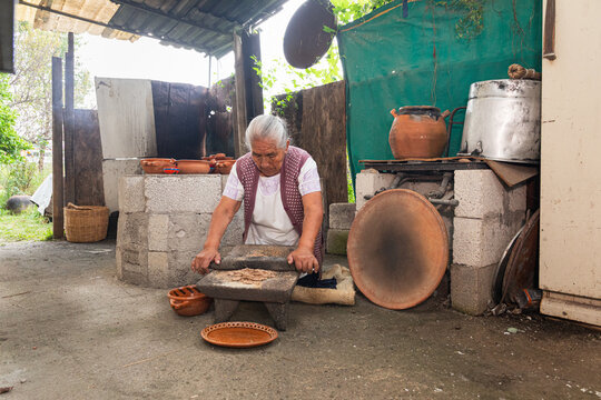 Woman preparing food in traditional kitchen