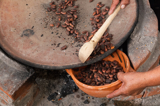 Collecting cacao beans from a comal in Mexico