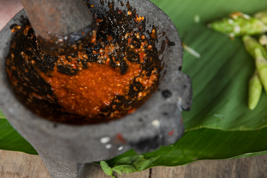 Vibrant chili salsa in a molcajete