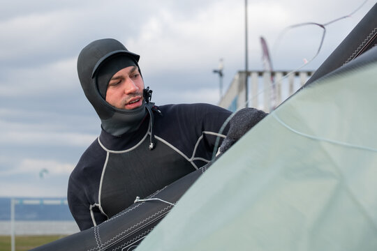 Kitesurfer Preparing Equipment on Shore
