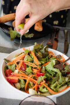 Squeezing Lime Over Salad
