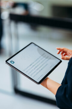 Person Holding Tablet In Modern Office Setting