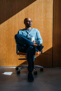 Relaxed Man Sitting In Office Chair