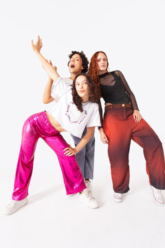 Trio of women styled in contemporary fashion on white background