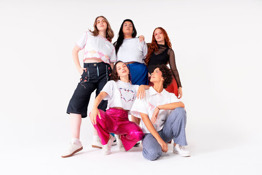 Five young women in modern fashion studio portrait