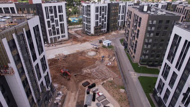 Drone advancing and pitching down over construction