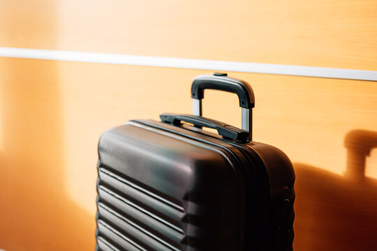 Interior view of travel suitcase placed against wall in modern setting