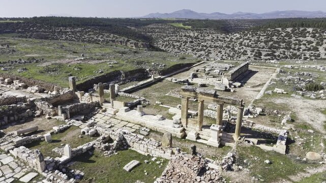 Cinematic aerial drone video footage of Blaundus Ancient City near Ulubey in Usak, Turkey, featuring ancient ruins, stone structures, and dramatic landscape from above in the Aegean region.