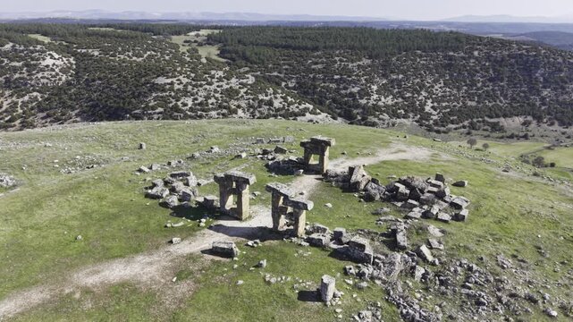 Cinematic aerial drone video footage of Blaundus Ancient City near Ulubey in Usak, Turkey, featuring ancient ruins, stone structures, and dramatic landscape from above in the Aegean region.