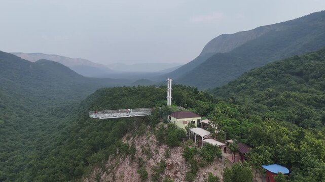 The Glass Bridge in Rajgir, Bihar, offers panoramic views of lush hills and valleys. Built with transparent tempered glass, it attracts tourists seeking adventure, scenic beauty, and elevated skywalk 