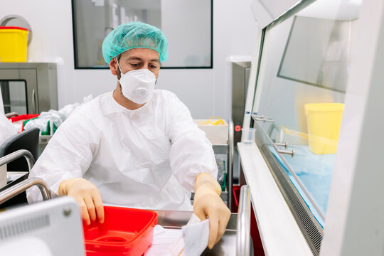 Pharmacist preparing medicine in sterile laboratory cleanroom
