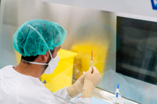 Scientist preparing syringe for vaccine in hospital pharmacy