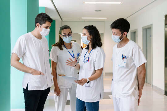 Hospital pharmacy staff collaborating and discussing medical records