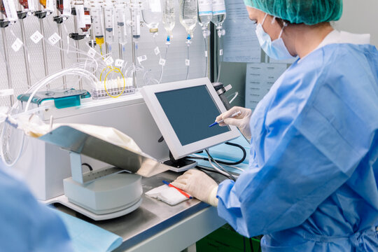 Pharmacist preparing medication using medical equipment in hospital