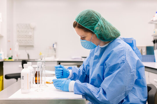 Pharmacist preparing medicine in sterile hospital laboratory