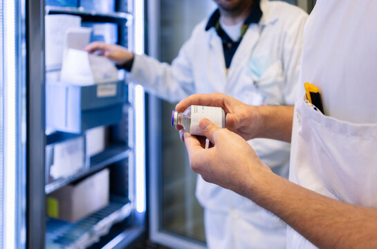 Pharmacist analyzing medication vial in hospital pharmacy