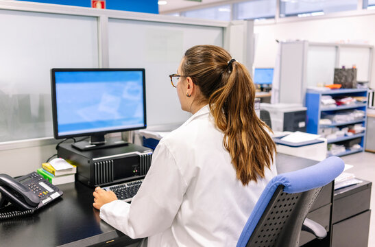 Pharmacist working at hospital pharmacy computer desk