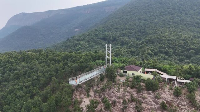 The Glass Bridge in Rajgir, Bihar, offers panoramic views of lush hills and valleys. Built with transparent tempered glass, it attracts tourists seeking adventure, scenic beauty, and elevated skywalk 