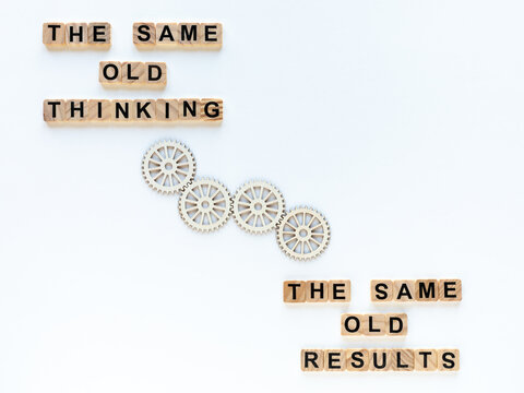 The same old results as a consequence of the same old thinking. Motivational quotes on wooden blocks, looping arrows between them. White background.