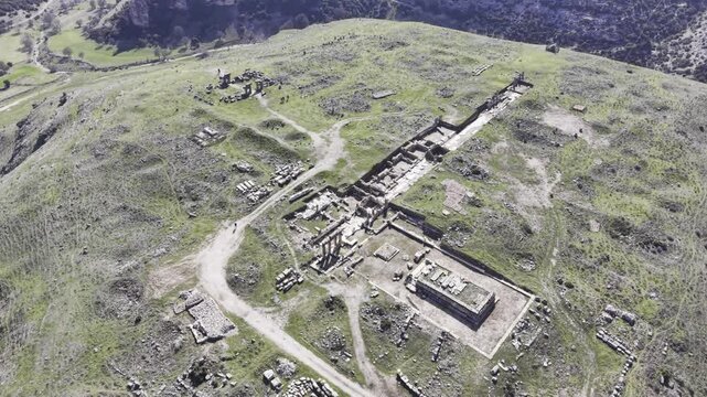 Cinematic aerial drone video footage of Blaundus Ancient City near Ulubey in Usak, Turkey, featuring ancient ruins, stone structures, and dramatic landscape from above in the Aegean region.
