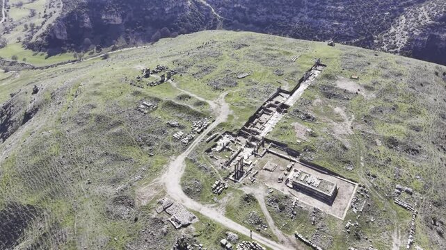 Cinematic aerial drone video footage of Blaundus Ancient City near Ulubey in Usak, Turkey, featuring ancient ruins, stone structures, and dramatic landscape from above in the Aegean region.