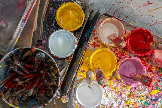Lots of cans of colored paints for drawing and Artist brushes