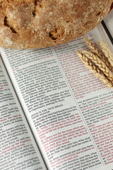 Christian holy bible with bread and wheat. Spiritual food, biblical concept.