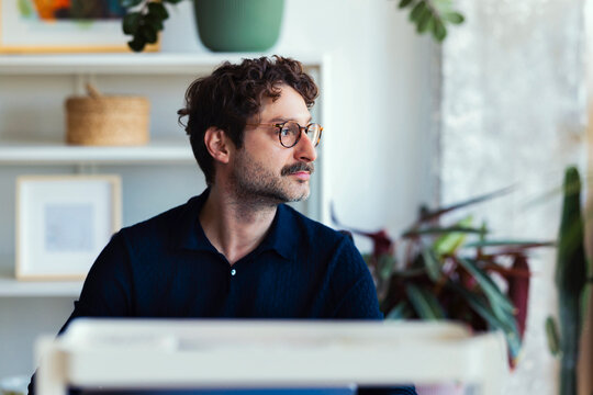 Man At Desk Looking Out The Window