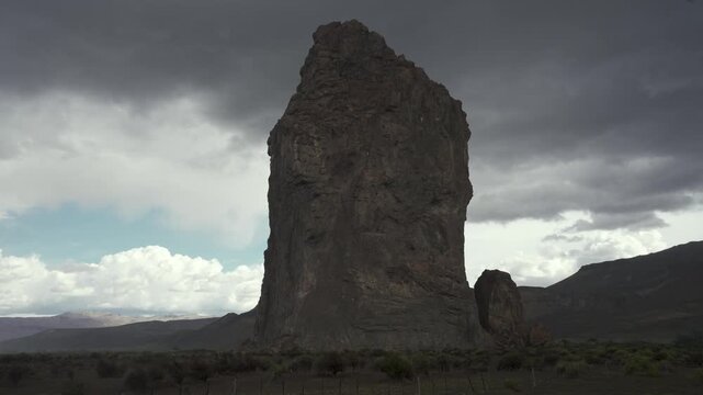 Piedra Parada natural protected area under a stormy sky with dark rain clouds and a mountain landscape. Chubut, Argentina