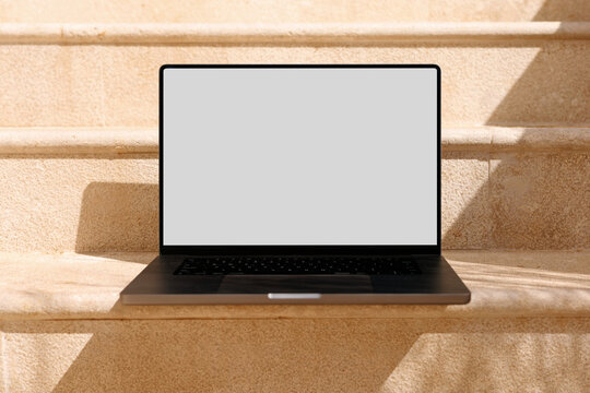 Laptop mockup with blank screen on outdoor steps