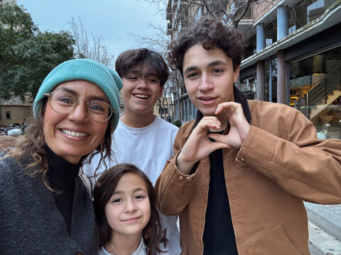 Family Taking a Selfie on the Street in a City